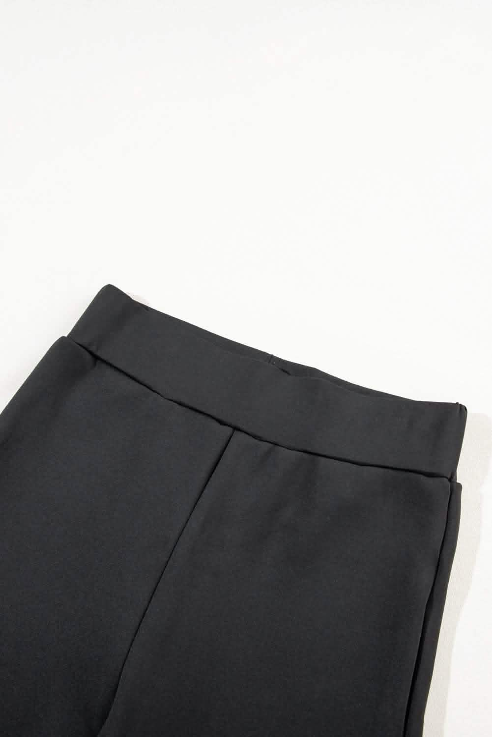 Close-up view of the Cozy Black High-waist Sport Leggings showcasing the wide, comfortable waistband and sleek black fabric.