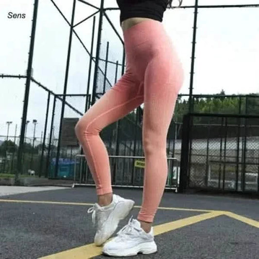 Pink athletic leggings with white sneakers.