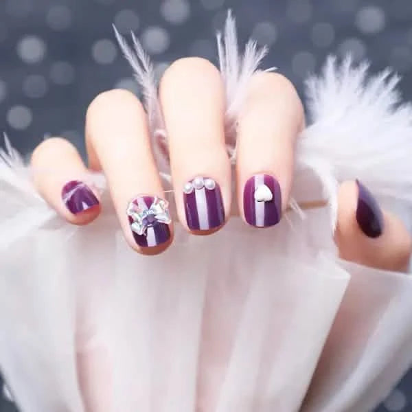 Wearing Nails With Diamonds And Purple Fake Nails.