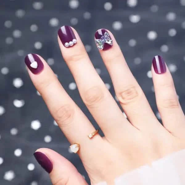 Wearing Nails With Diamonds And Purple Fake Nails.