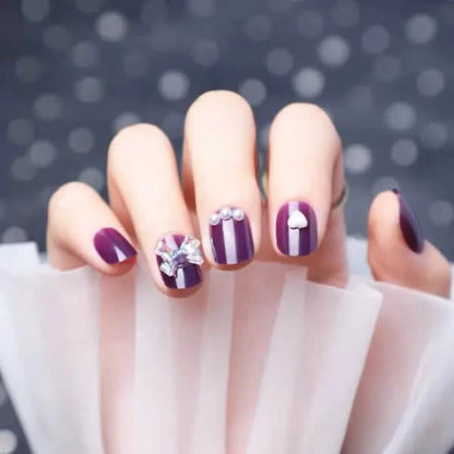 Wearing Nails With Diamonds And Purple Fake Nails.