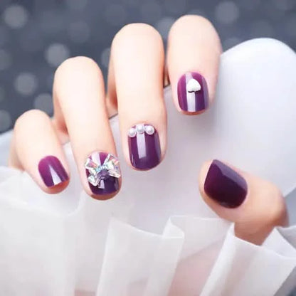 Wearing Nails With Diamonds And Purple Fake Nails.