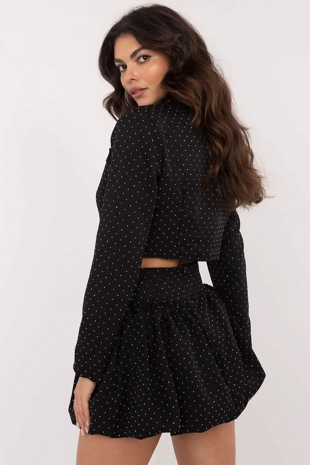 Black polka dot two-piece outfit with a cropped top and flared skirt.