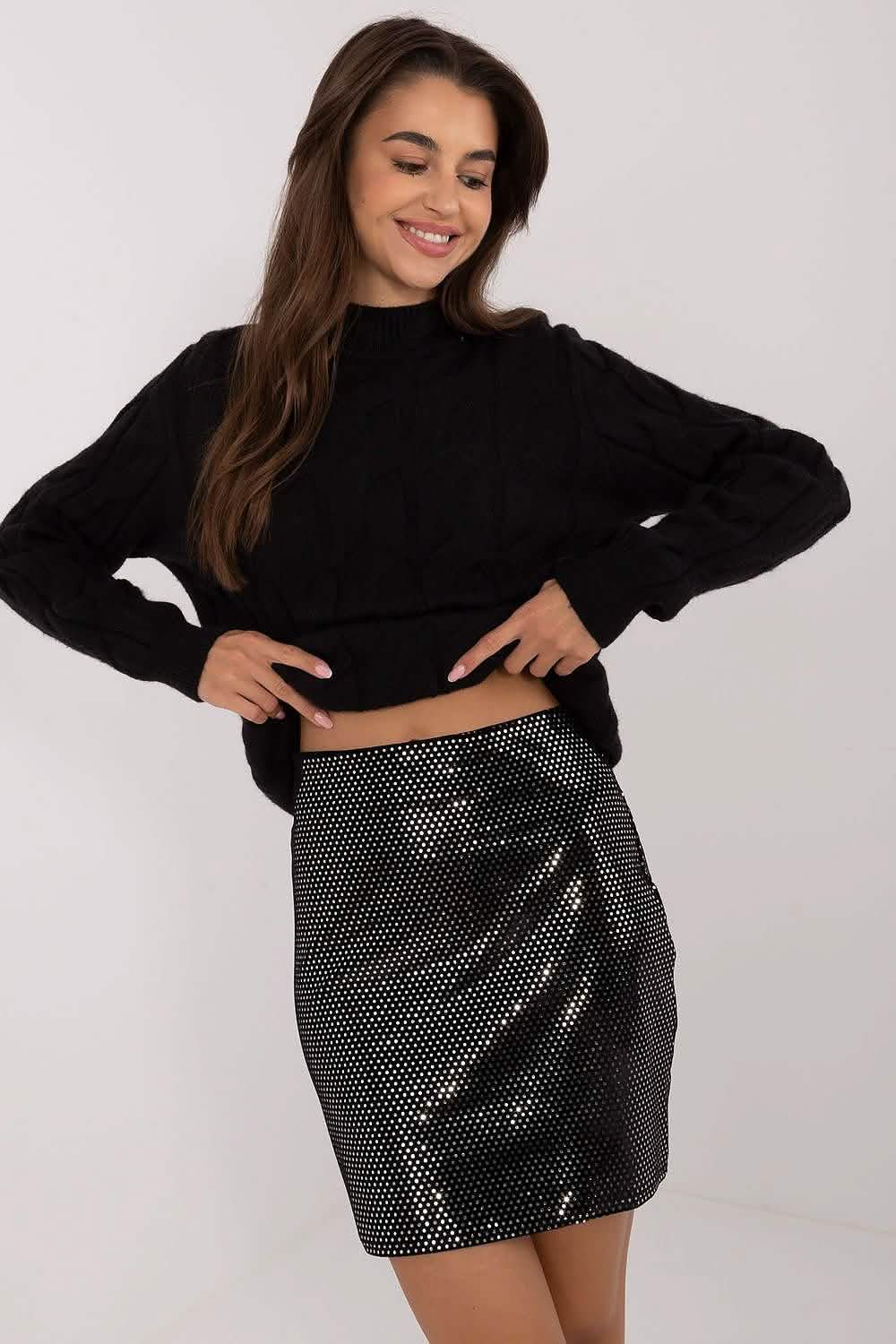 Sparkly metallic mini skirt paired with a black sweater.