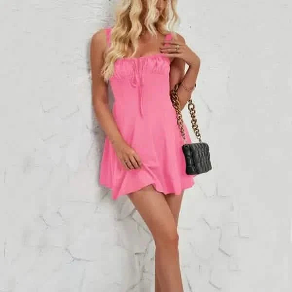 Pink sleeveless mini dress with a flowy silhouette.