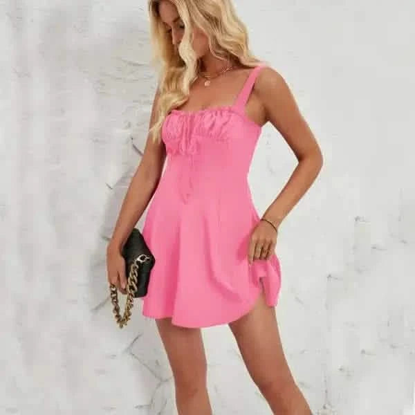 Pink sleeveless mini dress with ruffle detail and spaghetti straps.