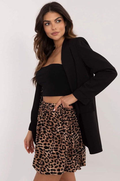 A black blazer paired with a leopard print skirt and black crop top.