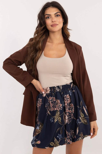 A brown blazer worn with a beige tank top and navy floral skirt.