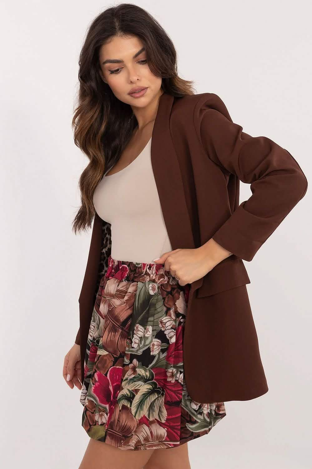 Brown blazer paired with a floral print skirt and beige top.