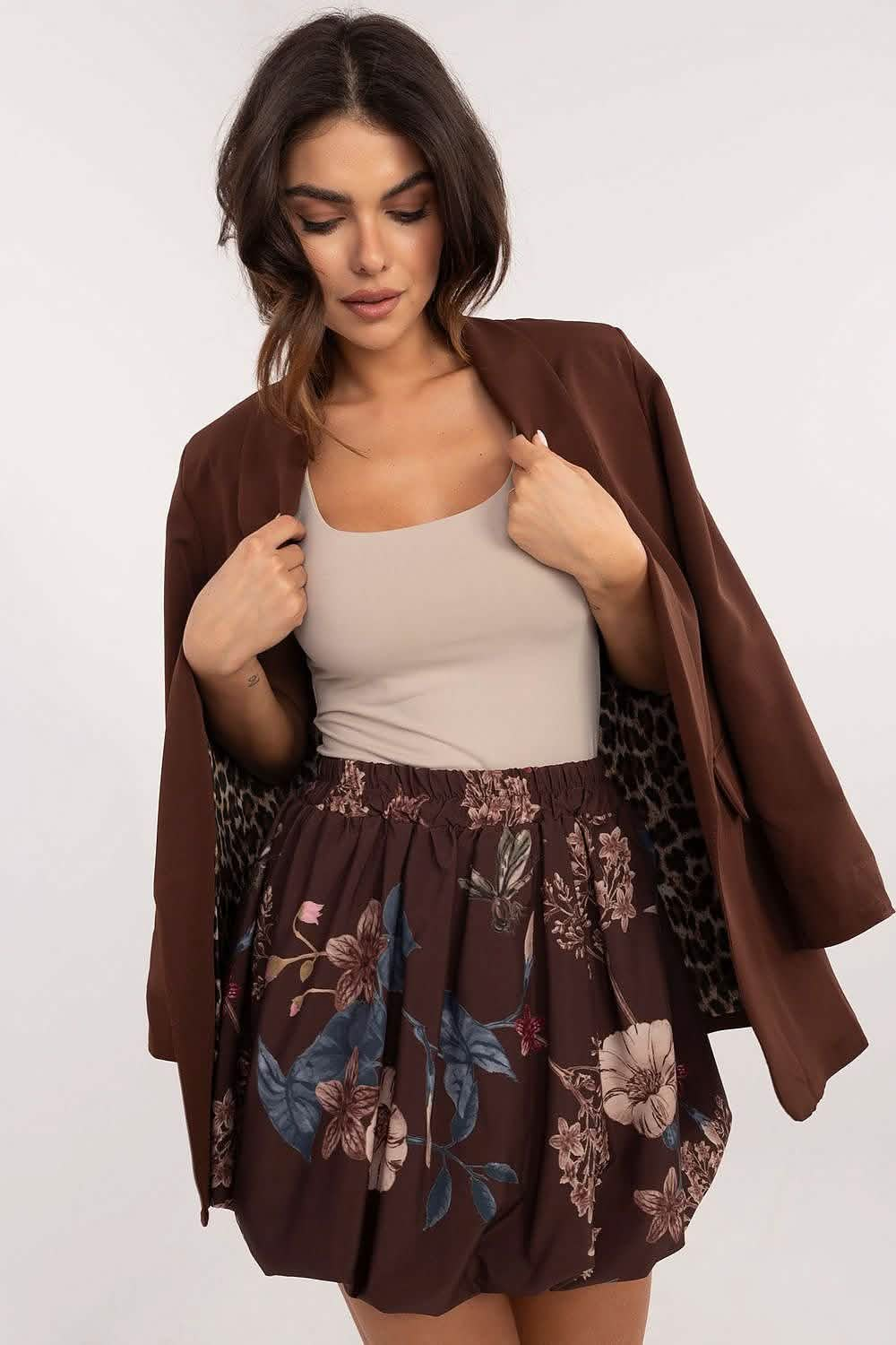 Brown floral skirt paired with a beige tank top and chocolate brown blazer.