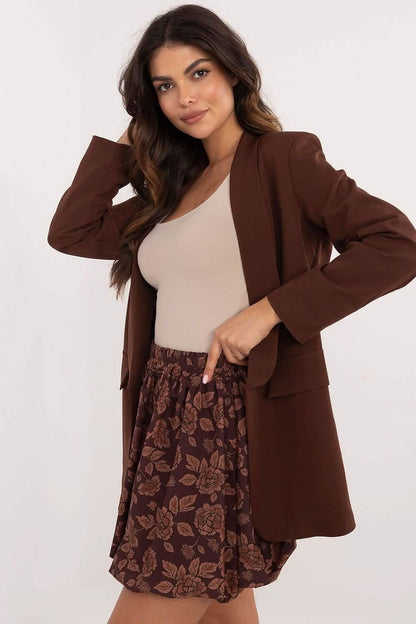 Brown blazer paired with a floral skirt and beige top.