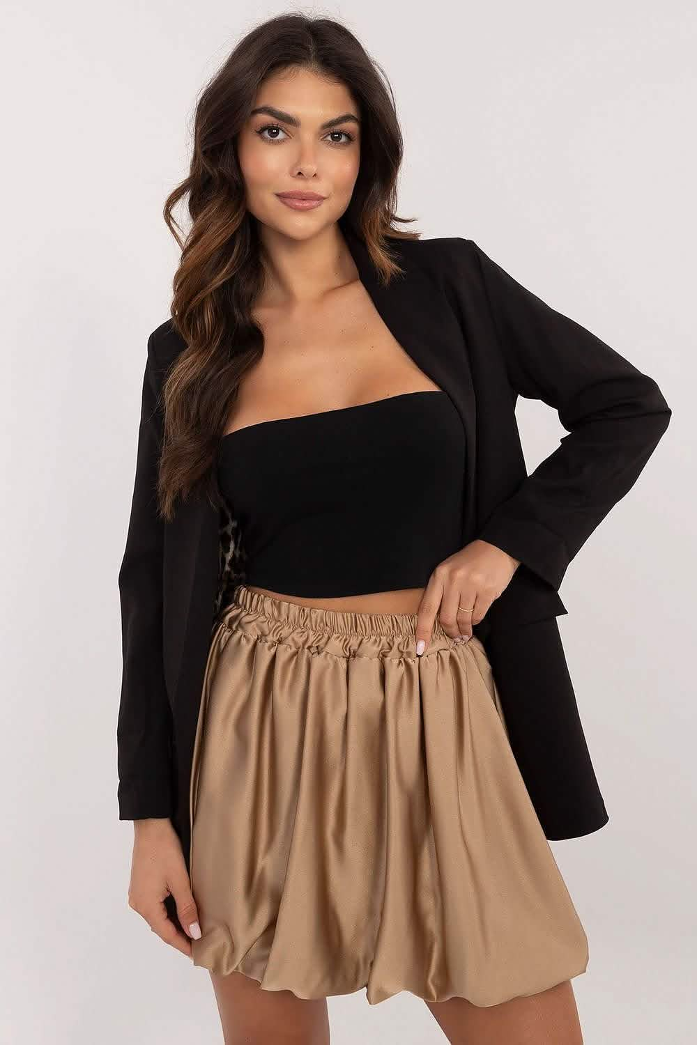 Tan bubble skirt paired with a black crop top and blazer.