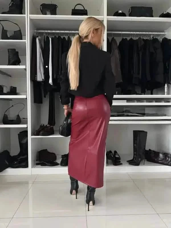 Burgundy leather pencil skirt worn with a black sweater.