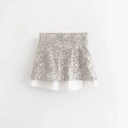 Flared skirt with snakeskin print pattern and white trim at the hem.