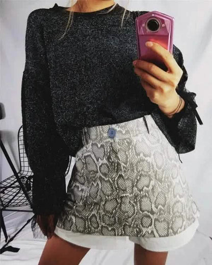 Mirror selfie showing a sparkly black sweater paired with a snakeskin print skirt.