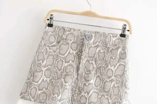 Snakeskin print skirt or fabric panel held by clips.