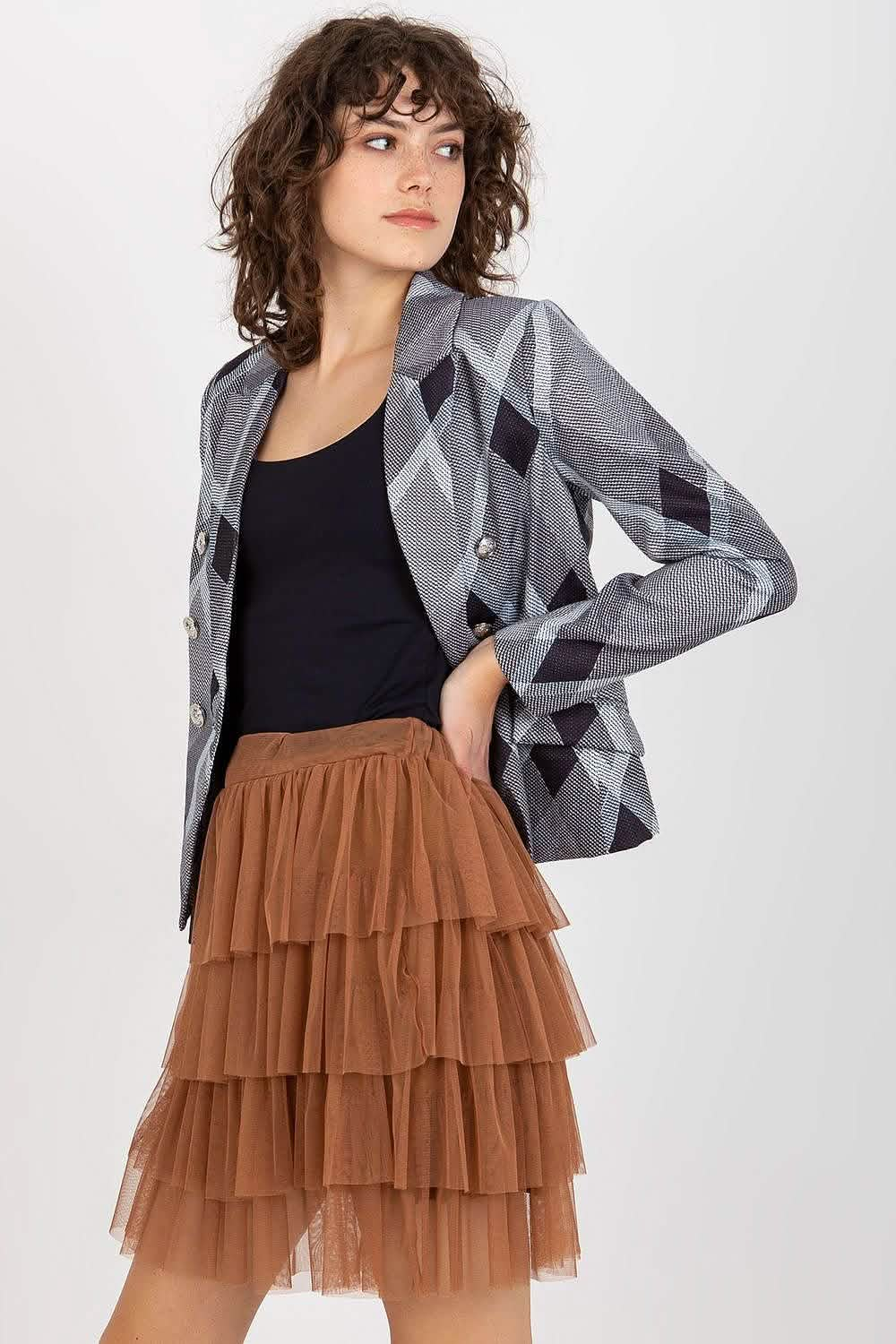 Geometric patterned gray blazer paired with a black top and tiered brown tulle skirt.