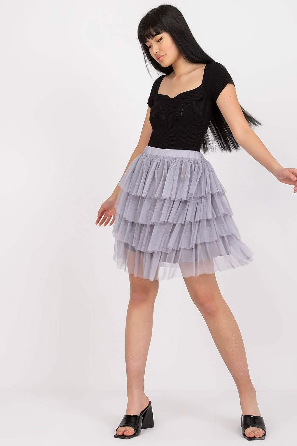 Layered tulle skirt in light gray with a fitted black top.