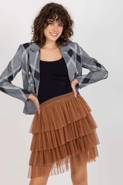 Brown tiered tulle skirt paired with a black top and argyle print blazer.