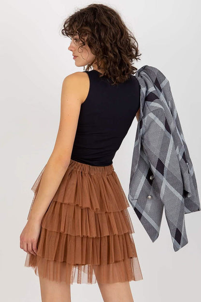 Brown tiered tulle skirt with ruffled layers paired with a black sleeveless top.