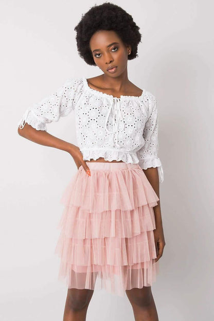 Pink tiered tulle skirt paired with a white eyelet crop top.