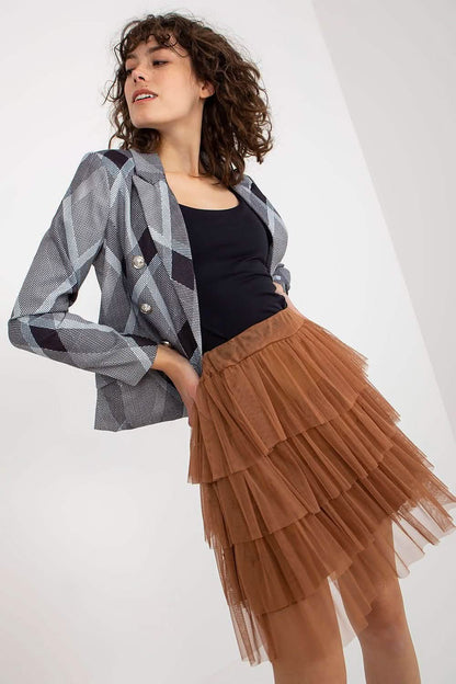 A tiered brown tulle skirt paired with a gray blazer and black top.