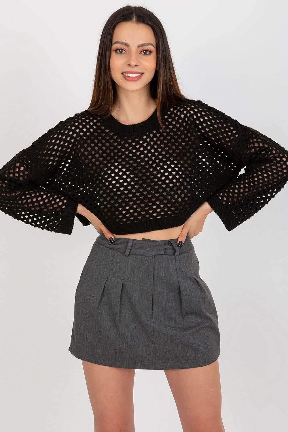 Black mesh cropped sweater with bell sleeves paired with a gray mini skirt.