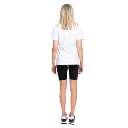 Person wearing a white t-shirt and black cycling shorts standing with their back turned.