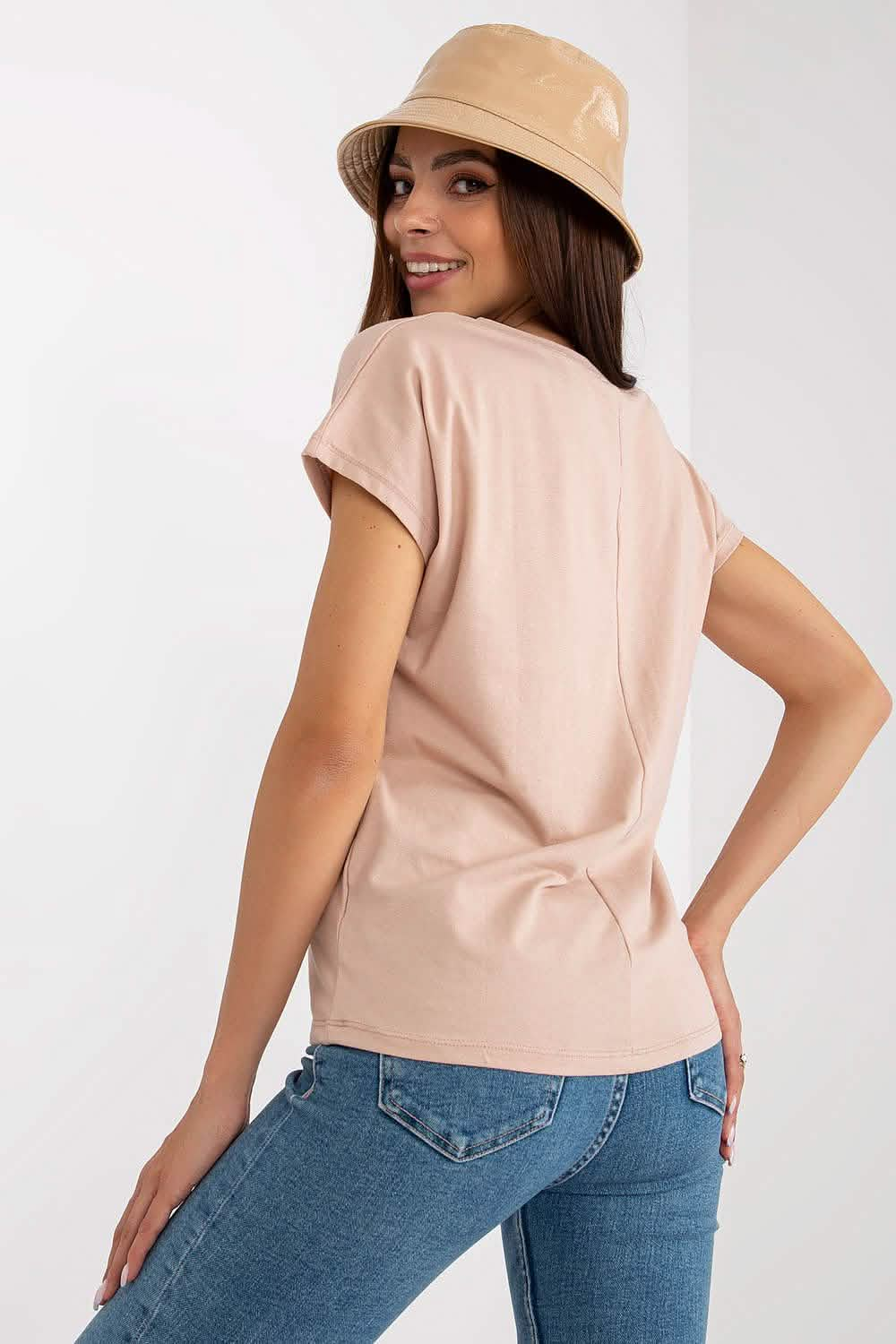 Peach-colored short-sleeve blouse with a subtle back twist detail.