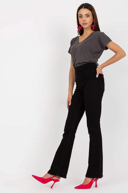 Black flared pants paired with a grey t-shirt and red heels.