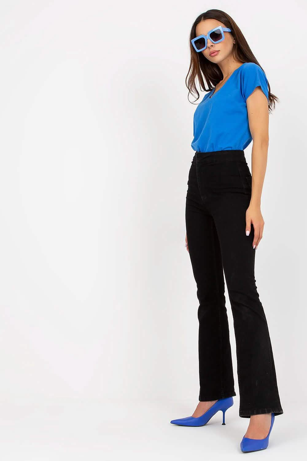 Black flared pants paired with a bright blue top and matching blue heels.