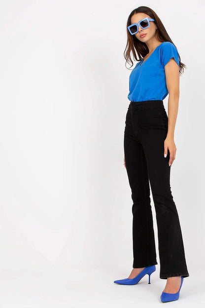 Black flared pants paired with a bright blue top and matching blue heels.