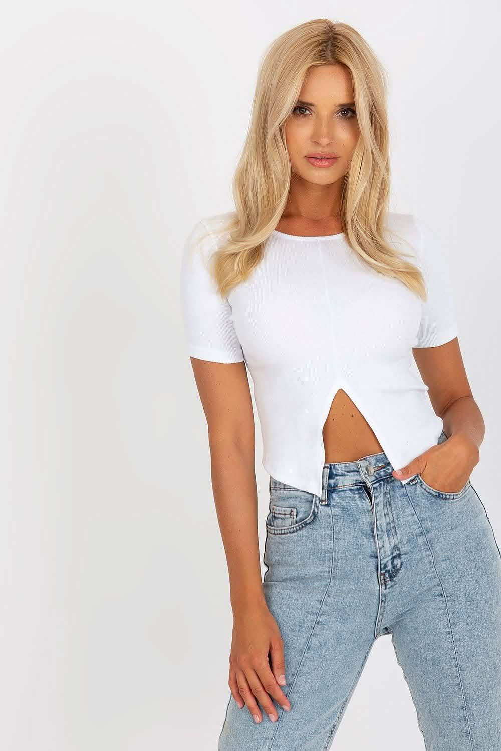 White cropped t-shirt with a cutout detail paired with light wash jeans.