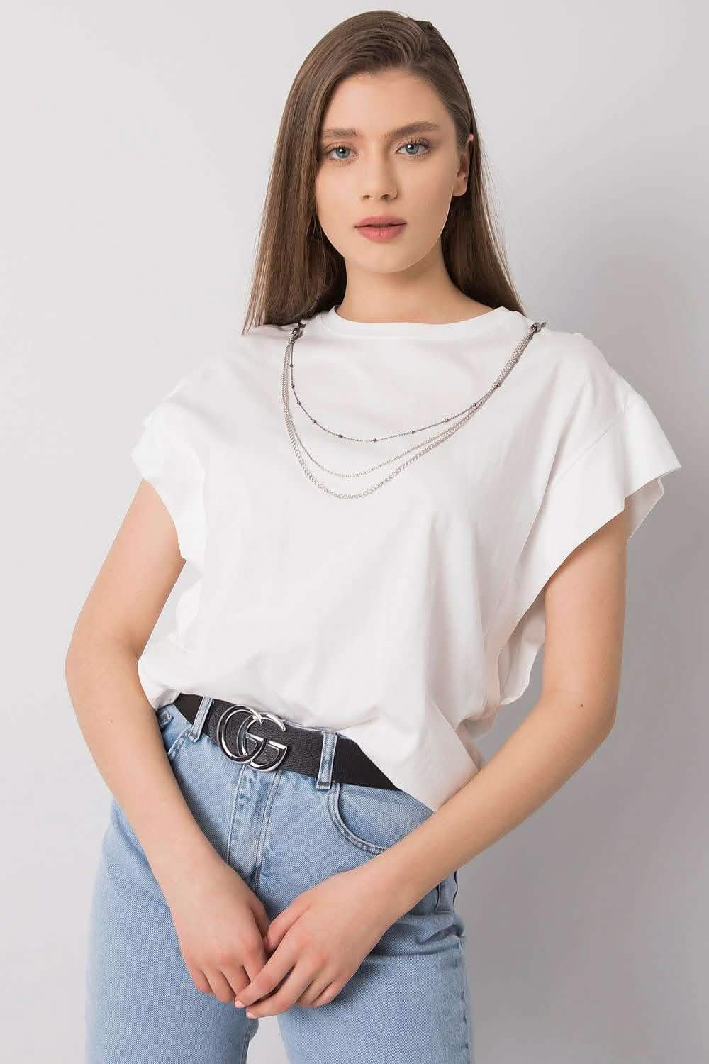 White cap-sleeve t-shirt with a layered silver chain necklace.