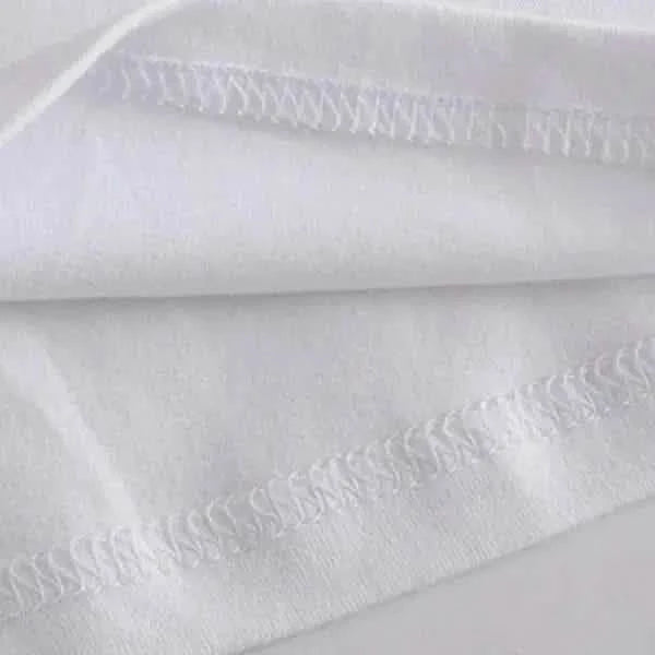 White fabric with decorative zigzag stitching.