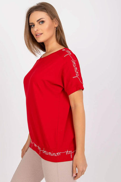 Red short-sleeved knit top with decorative text trim detailing.