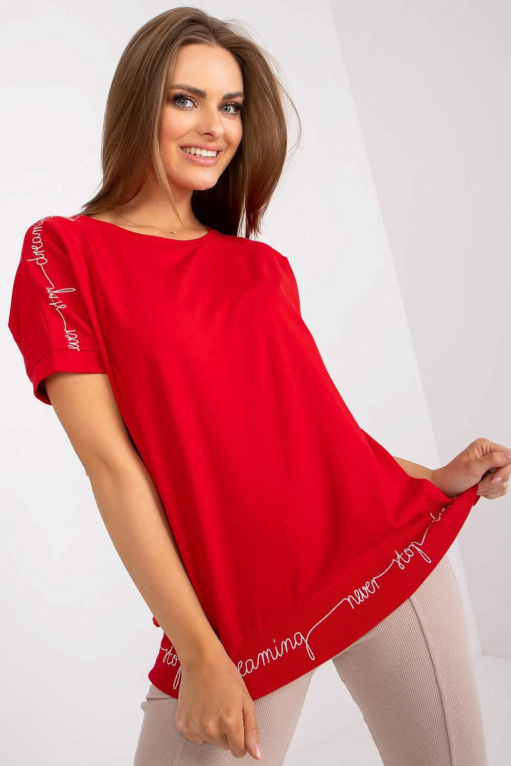 Bright red short-sleeved t-shirt with text detailing along the edges.