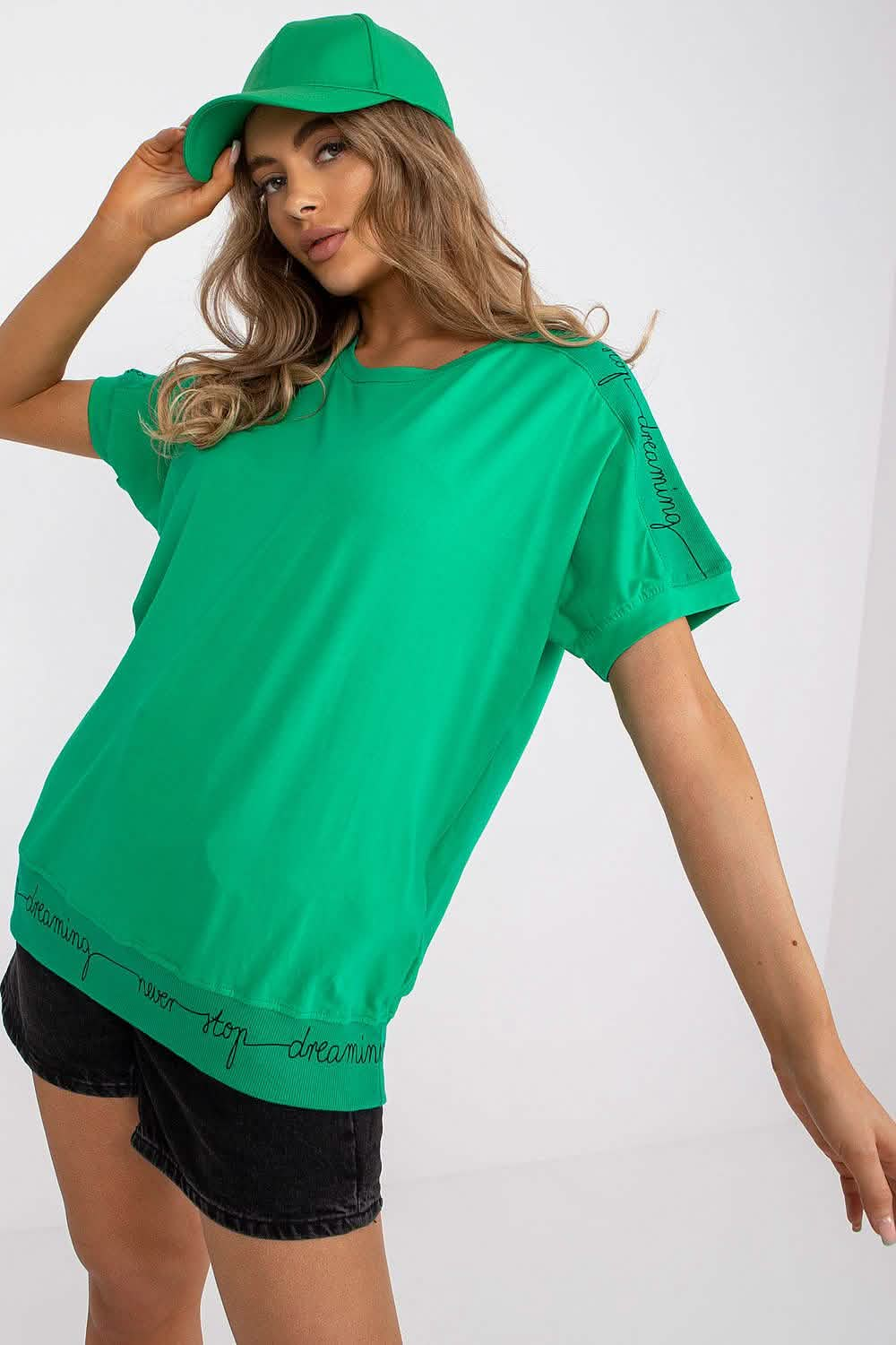 Bright green oversized t-shirt with matching baseball cap.