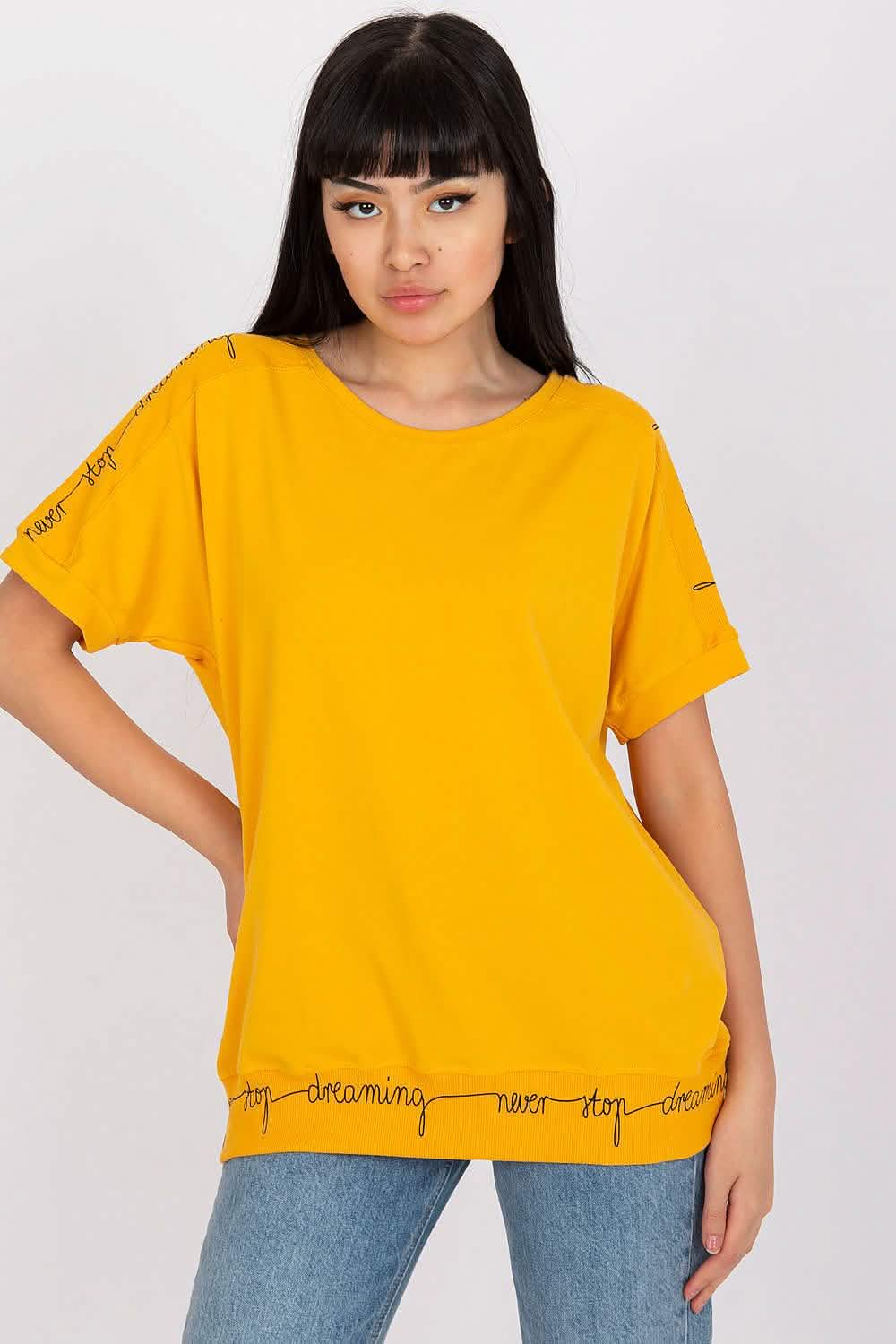 Bright yellow t-shirt with decorative text embellishments along the hem and sleeves.