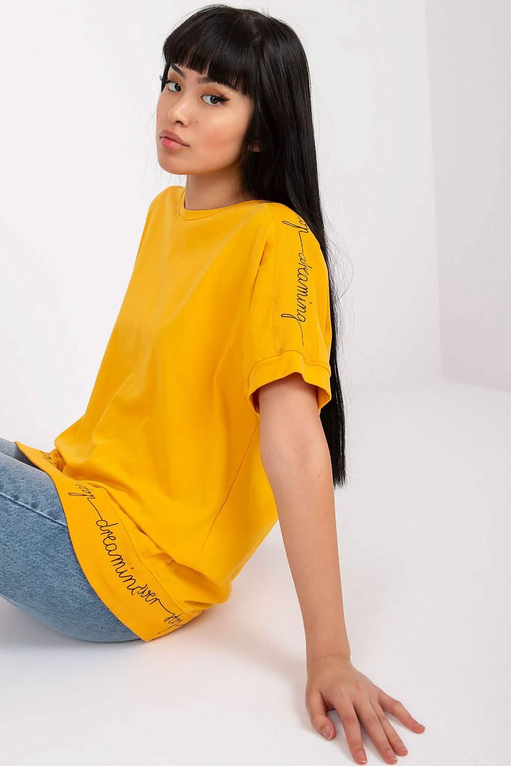 Bright yellow t-shirt with text details along the sleeve.