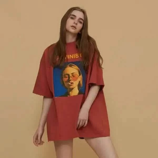 Red oversized t-shirt with a feminist graphic print.