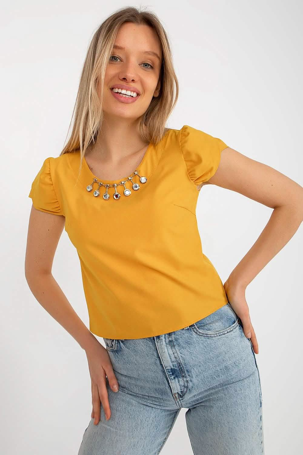 Bright yellow t-shirt with puff sleeves paired with light wash jeans.