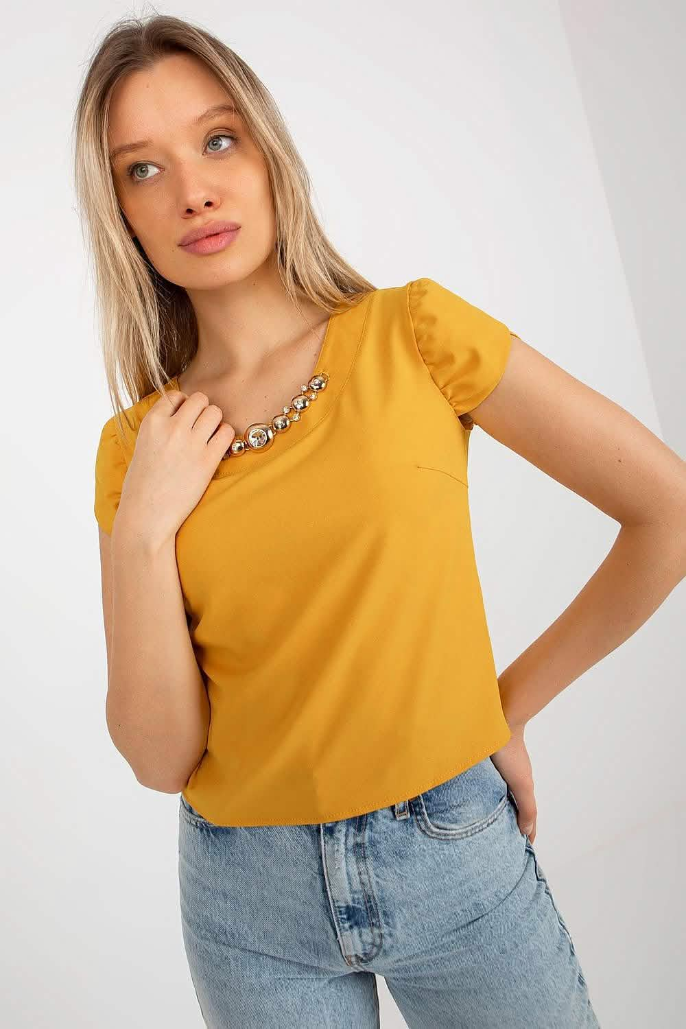 Mustard yellow puff-sleeve top with a decorative necklace detail.