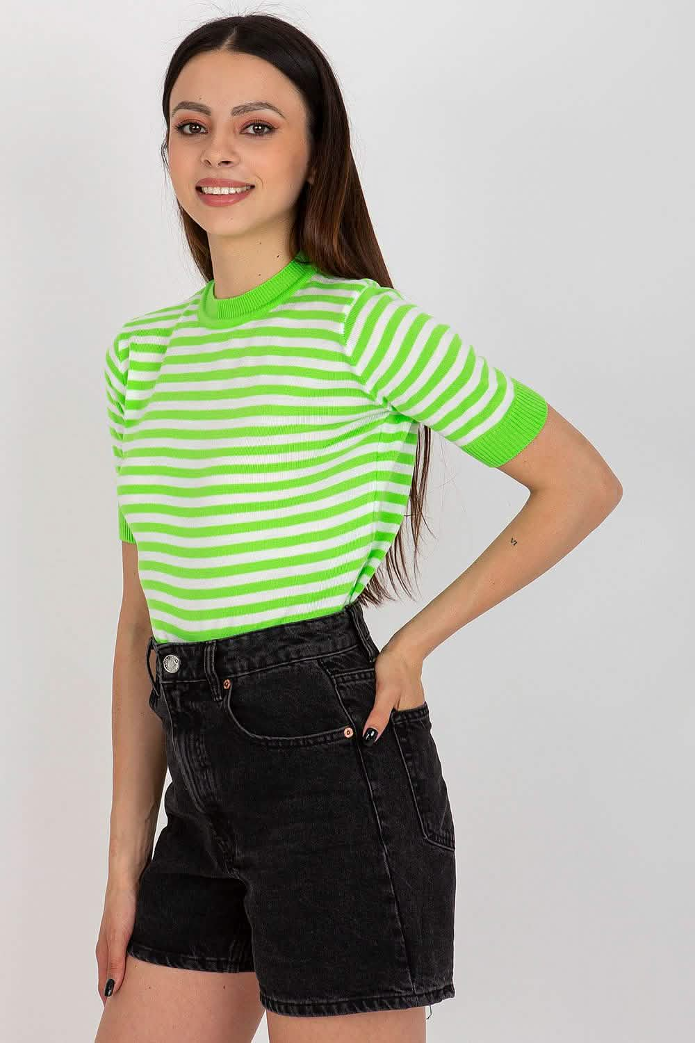 Bright green and white striped t-shirt paired with black denim shorts.