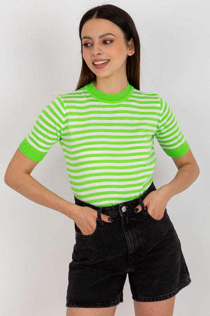 Bright green and white striped t-shirt paired with black denim shorts.