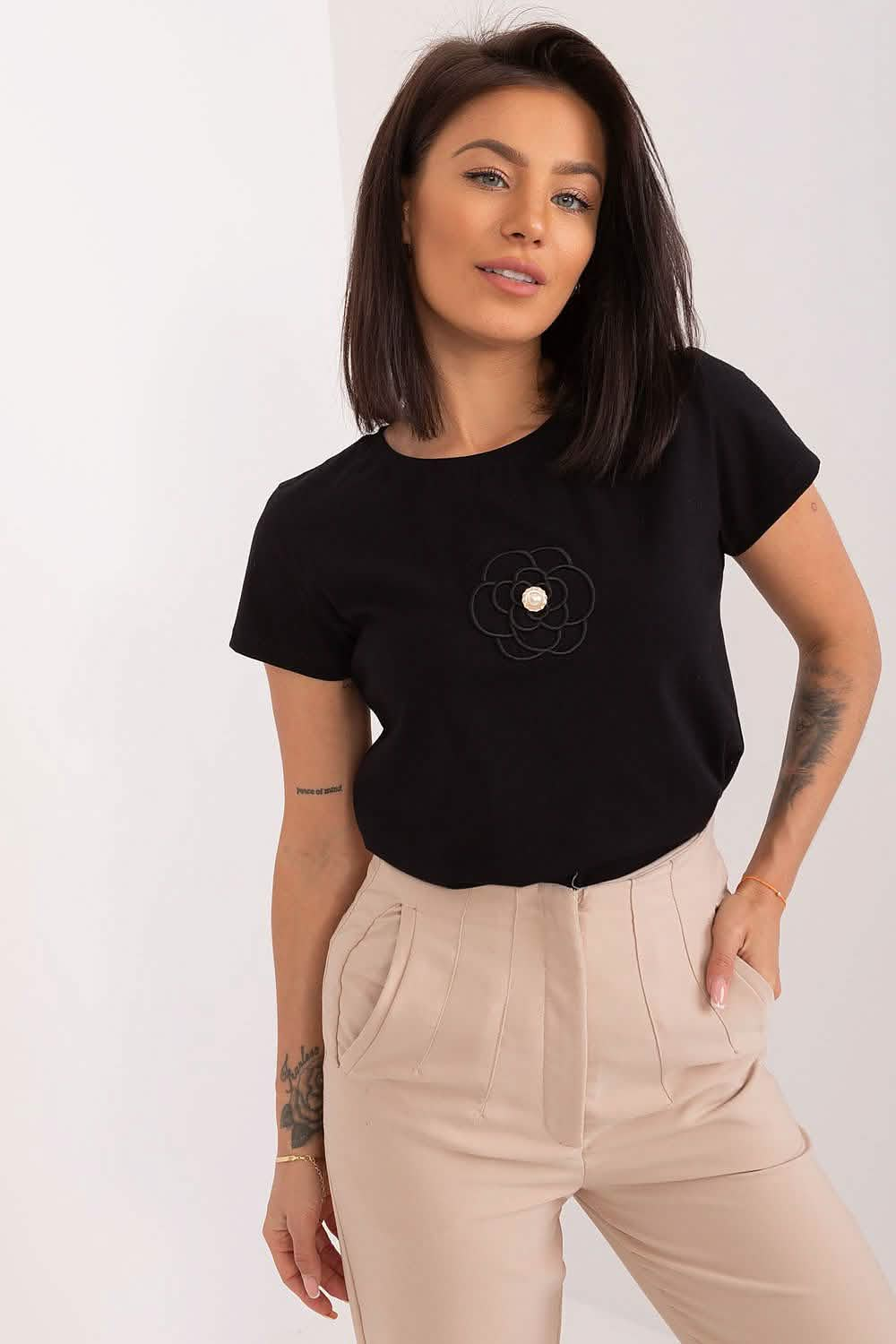 Black t-shirt with a small pocket detail on the chest.