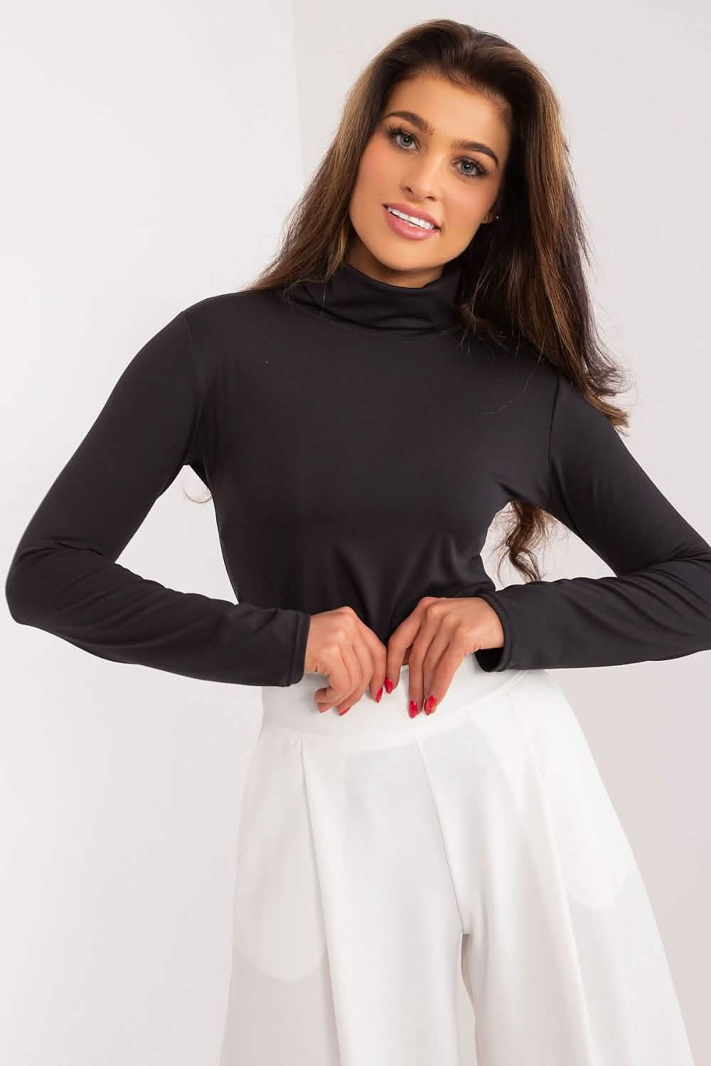 A black turtleneck sweater paired with white pants.