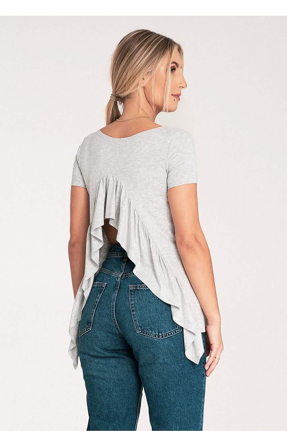 High-waisted blue jeans paired with a light gray ruffled top.