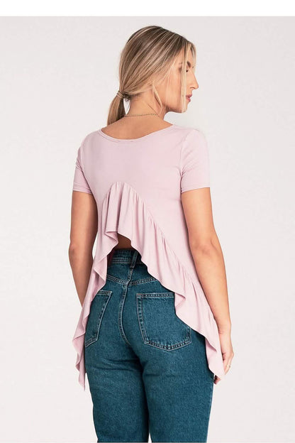 Pink short-sleeved top with a dramatic ruffled back hem worn with blue jeans.