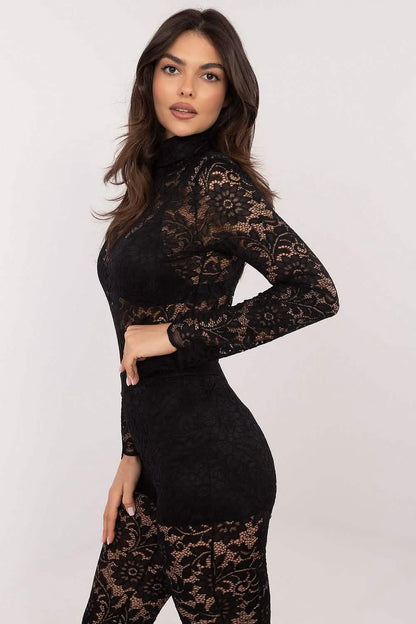 Black lace bodycon dress with long sleeves and sheer panels.